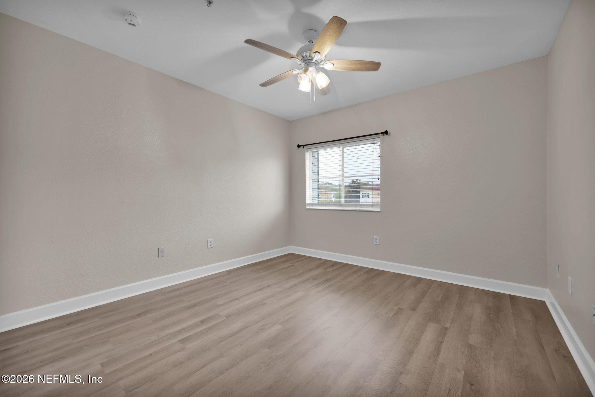9745 Touchton Road, Unit 526 Jacksonville, FL 32246 - Photo 22 of 34 an empty room with wooden floor and windows