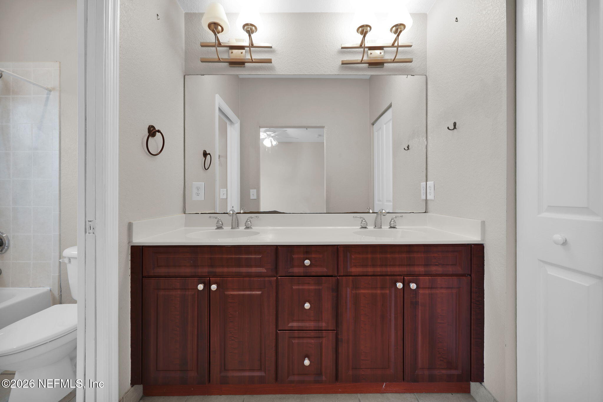 9745 Touchton Road, Unit 526 Jacksonville, FL 32246 - Photo 24 of 34 a bathroom with a sink vanity and a mirror
