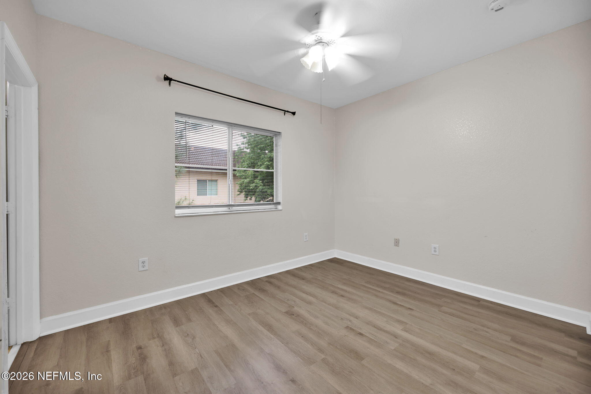 9745 Touchton Road, Unit 526 Jacksonville, FL 32246 - Photo 28 of 34 wooden floor in an empty room with a window