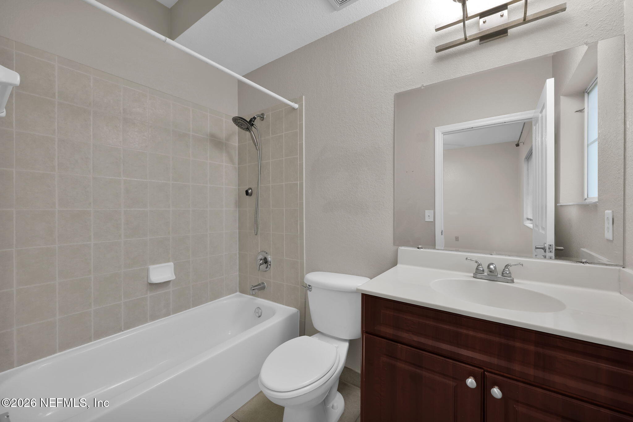 9745 Touchton Road, Unit 526 Jacksonville, FL 32246 - Photo 30 of 34 a bathroom with a sink a toilet and shower