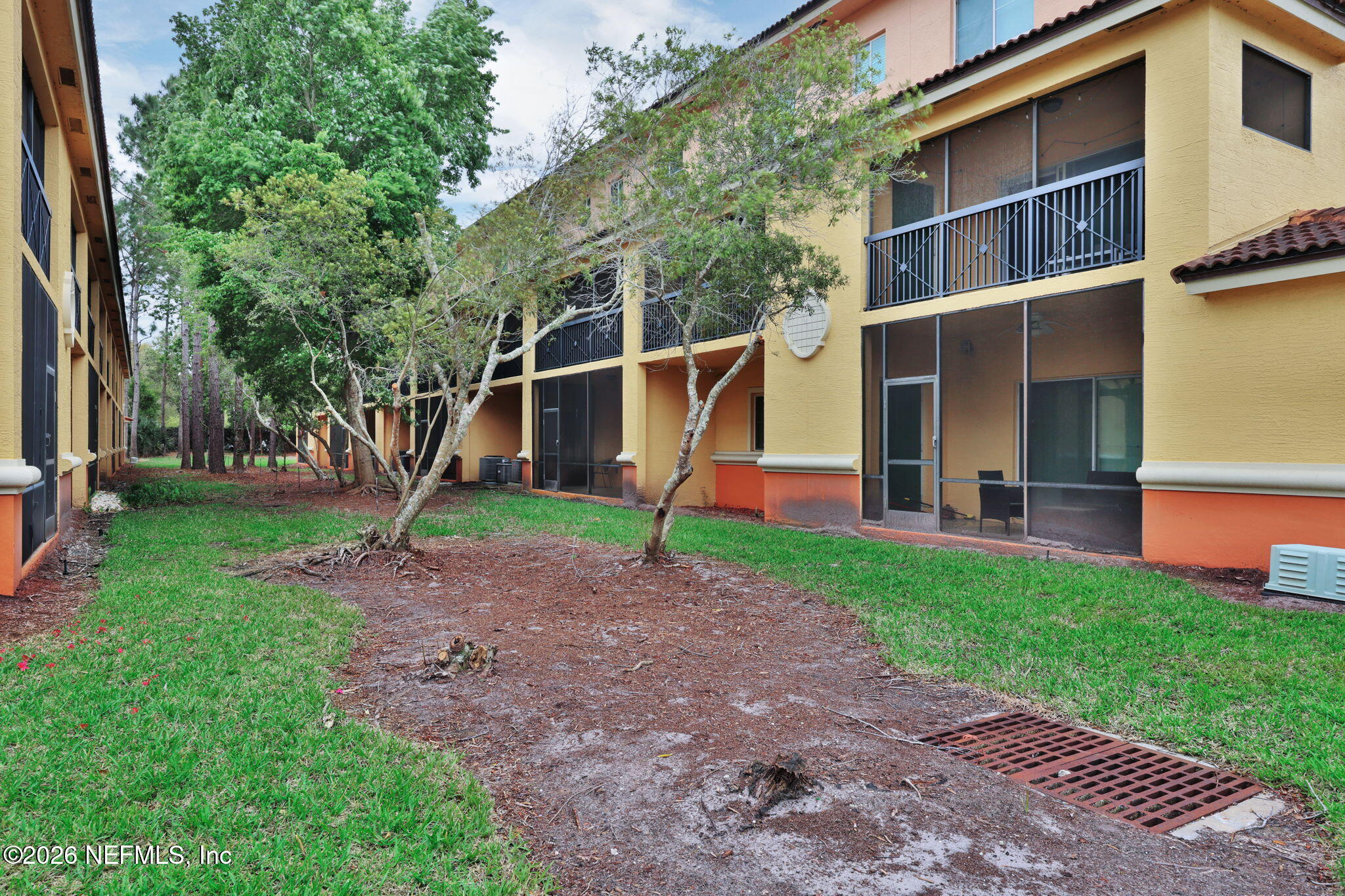 9745 Touchton Road, Unit 526 Jacksonville, FL 32246 - Photo 33 of 34 a backyard of a house with plants and wooden fence