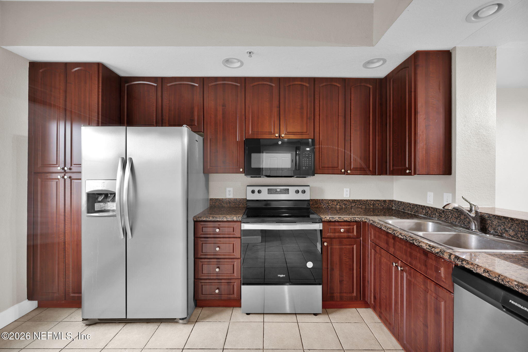 9745 Touchton Road, Unit 526 Jacksonville, FL 32246 - Photo 10 of 34 a kitchen with stainless steel appliances granite countertop a refrigerator and a sink