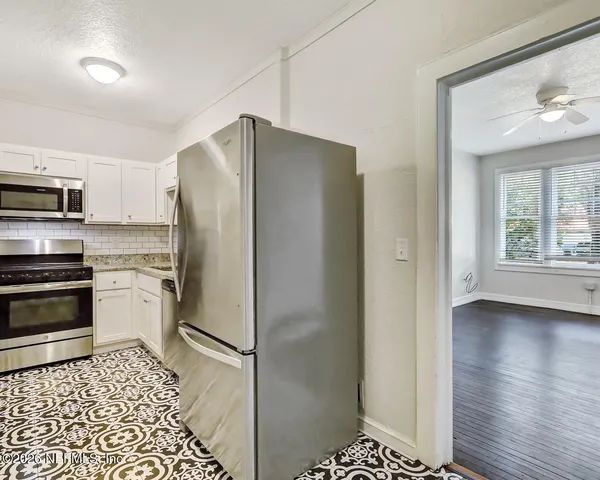 a kitchen with stainless steel appliances a refrigerator and a stove top oven