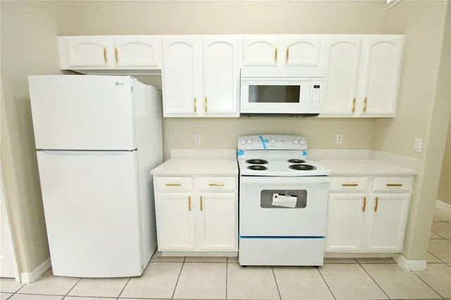 an empty room with a window and a ceiling fan