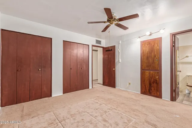 a view of a big room with wooden floor closet and windows
