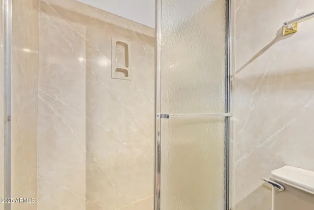 a bathroom with a glass shower door