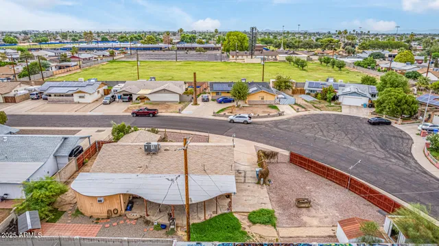an aerial view of a swimming pool and outdoor seating