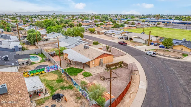 an aerial view of a house with a garden and lake view