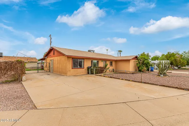 an aerial view of a house with a swimming pool patio and outdoor seating