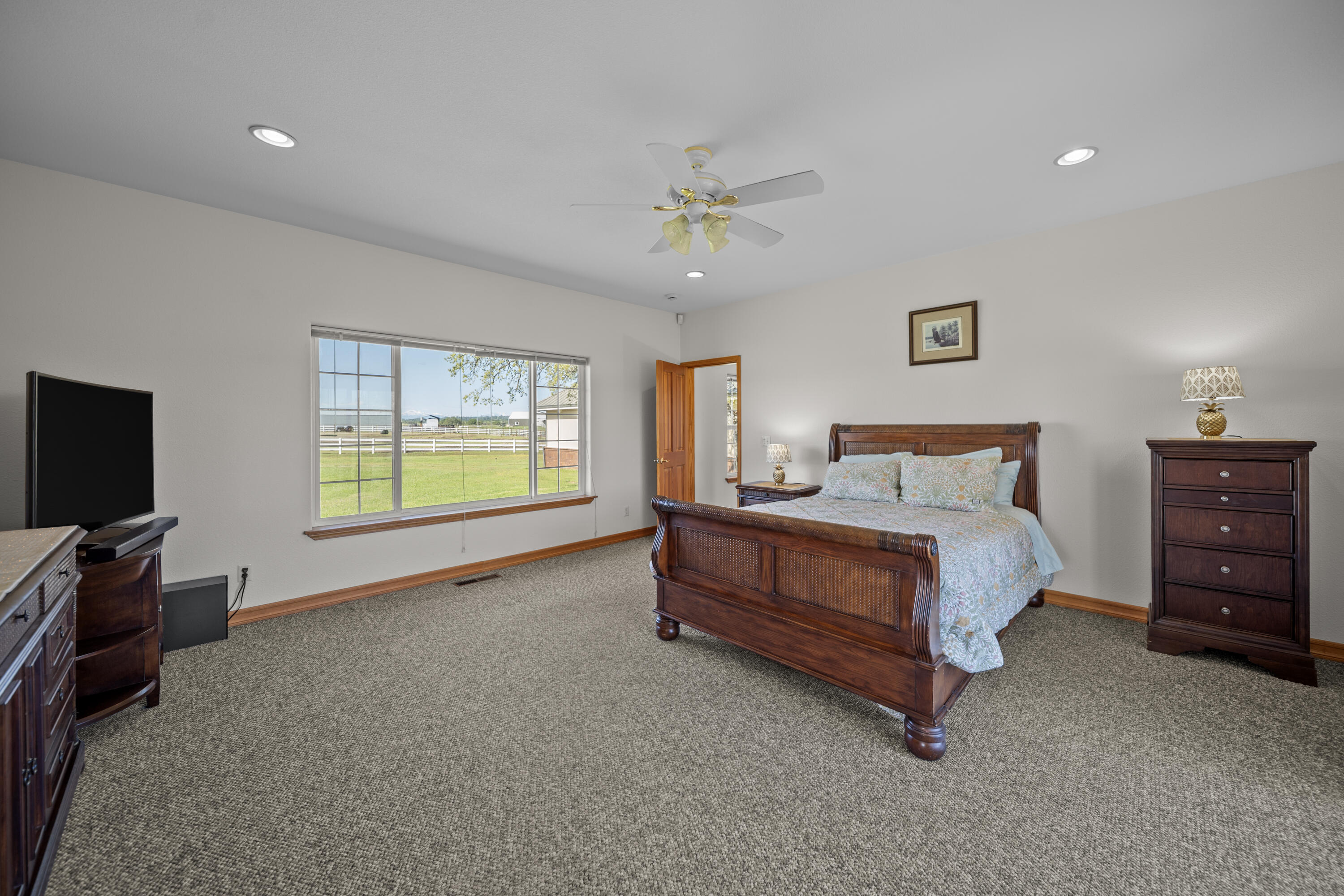 17935 Rivers Edge Drive Red Bluff, CA 96080 - Photo 17 of 38 a bedroom with a bed and a flat screen tv