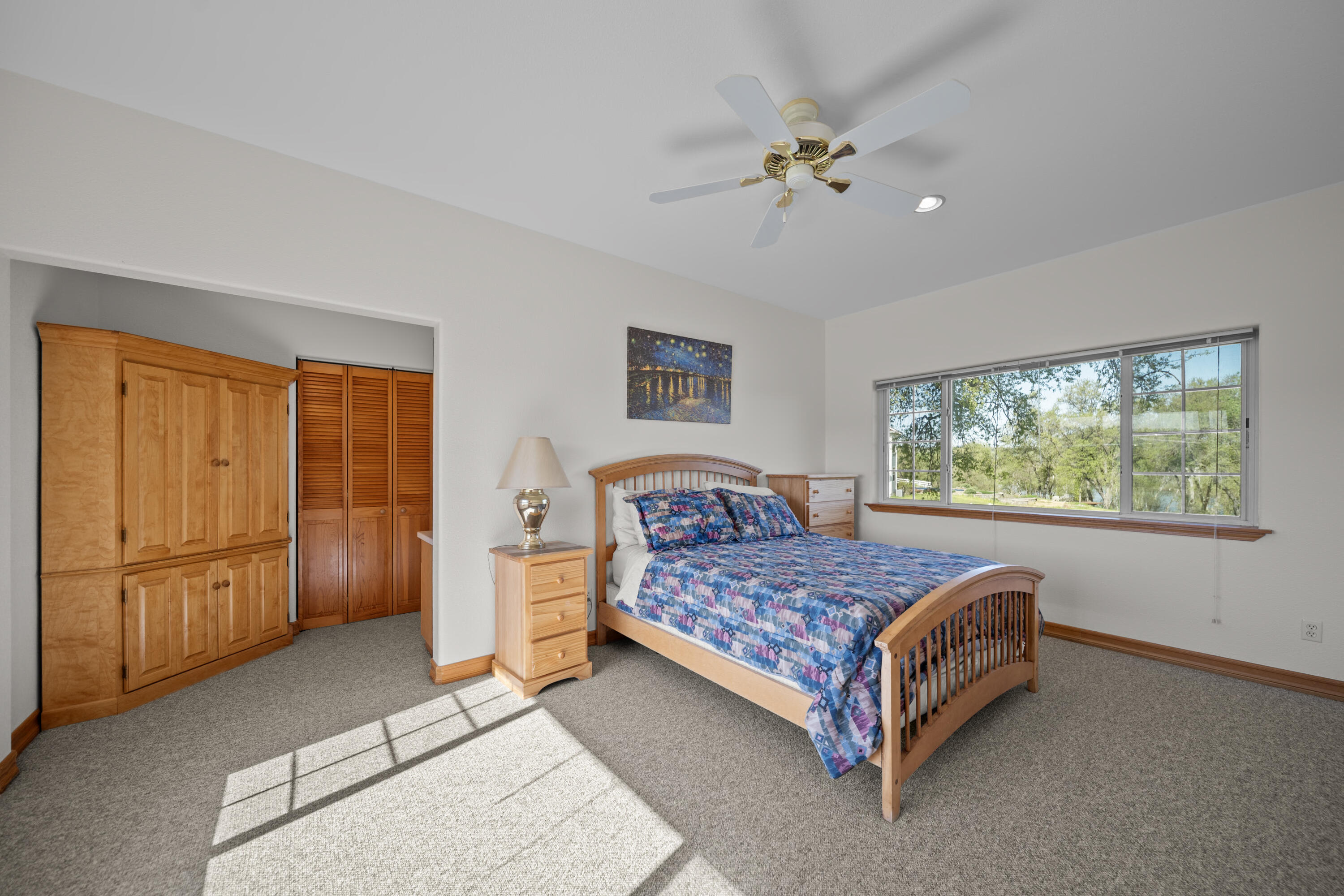 17935 Rivers Edge Drive Red Bluff, CA 96080 - Photo 22 of 38 a bedroom with a bed and a chandelier