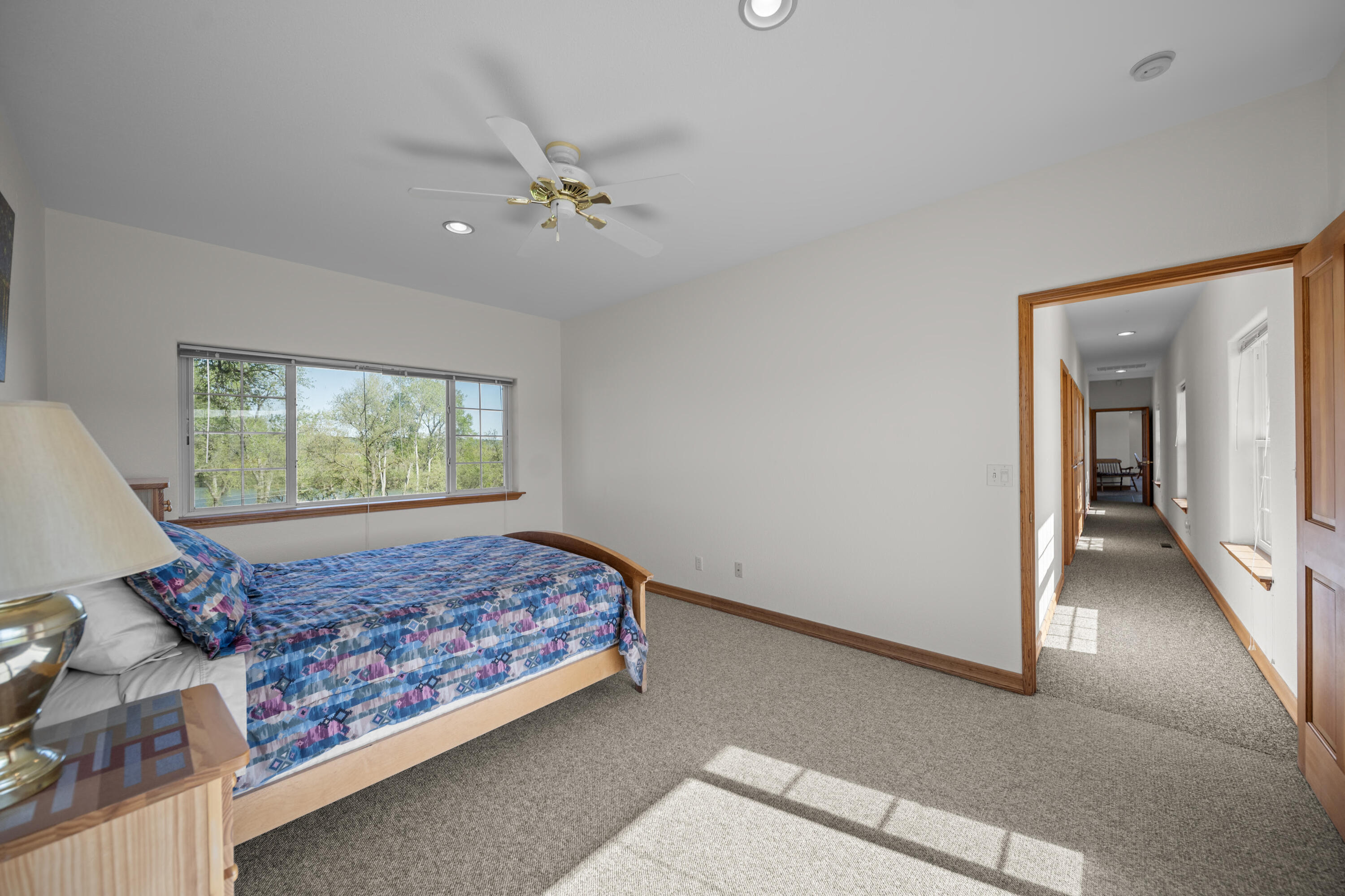 17935 Rivers Edge Drive Red Bluff, CA 96080 - Photo 23 of 38 a bed sitting in a spacious bedroom next to a window