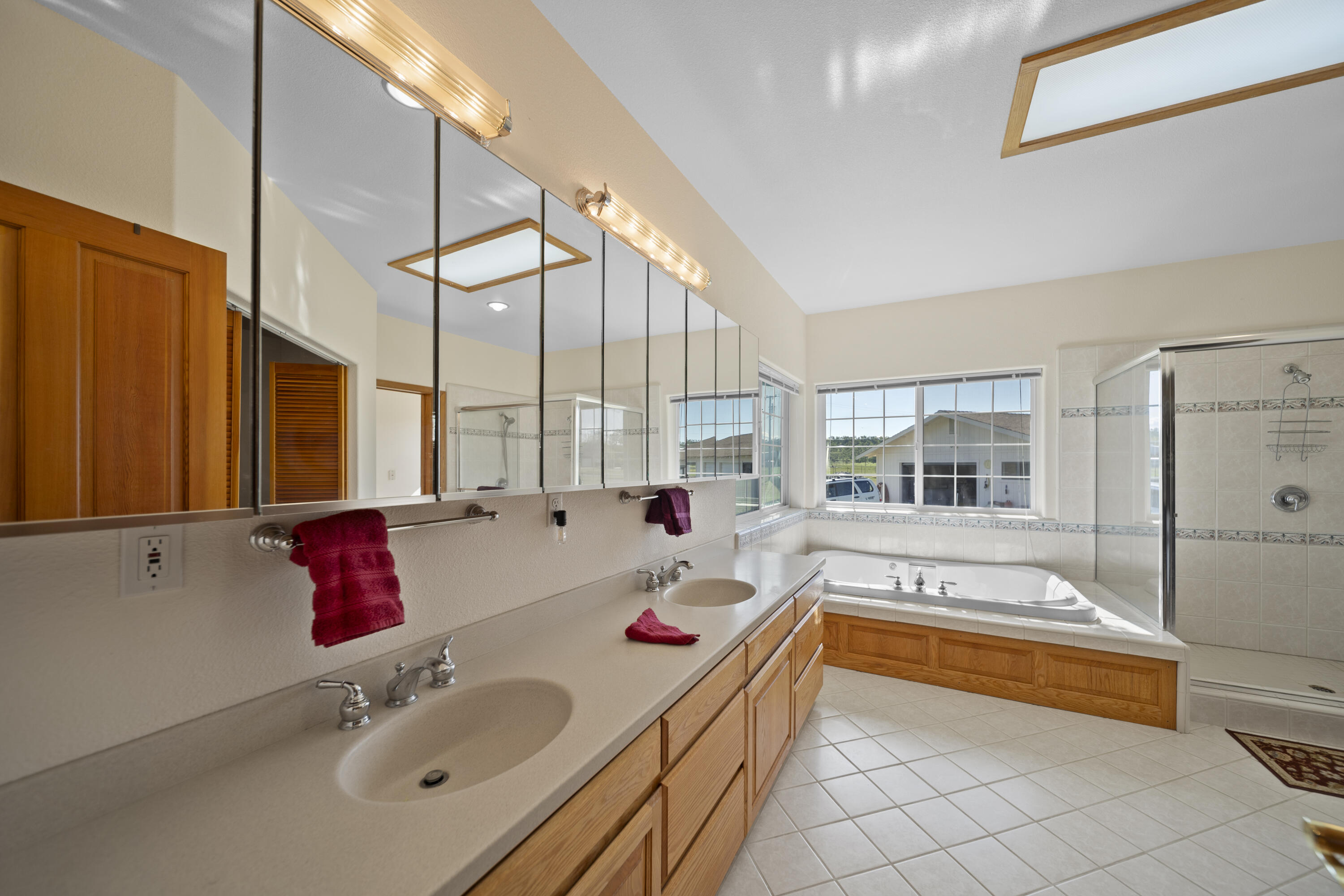 17935 Rivers Edge Drive Red Bluff, CA 96080 - Photo 30 of 38 a bathroom with a tub sink and a large mirror next to a window