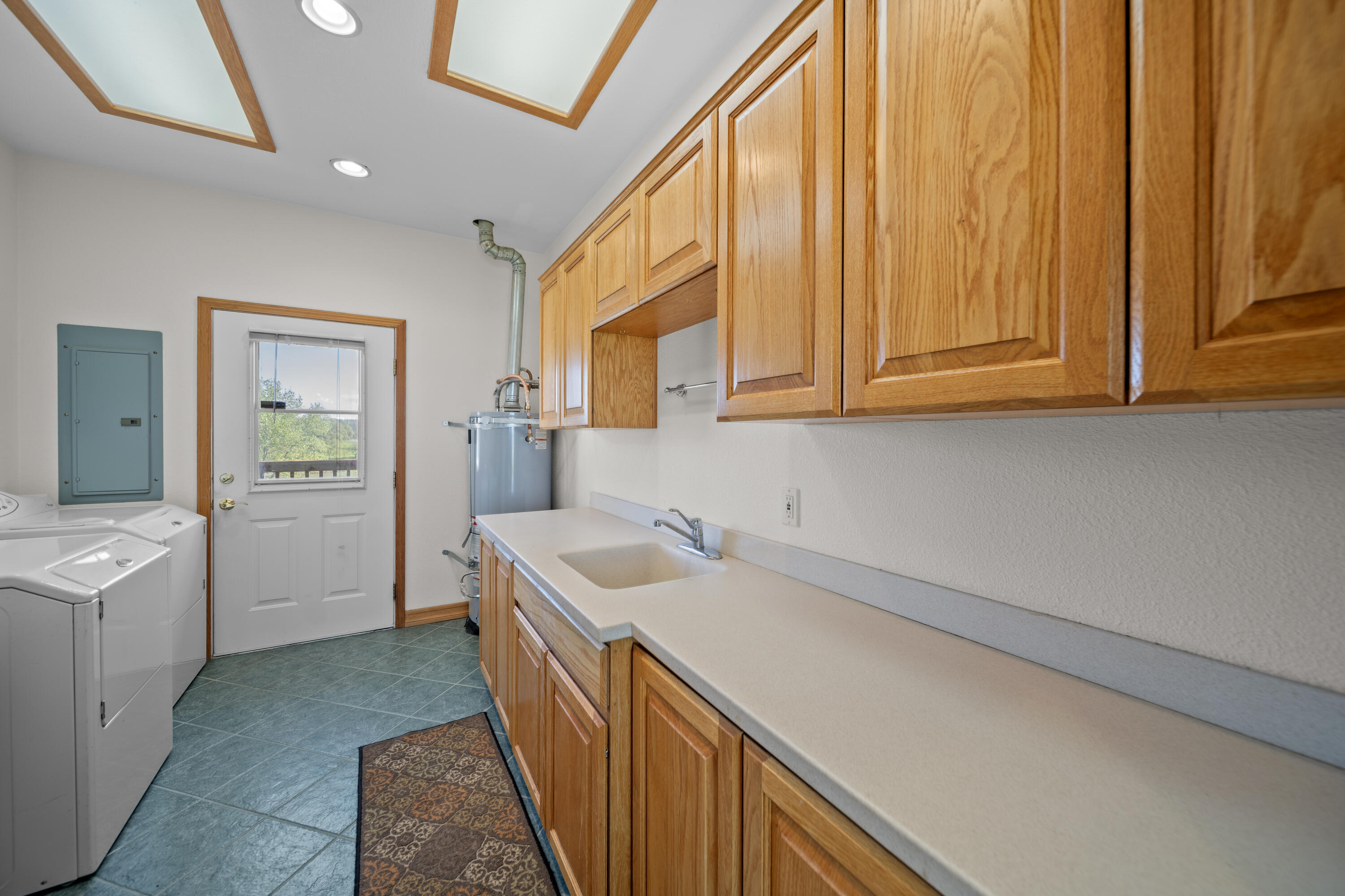 17935 Rivers Edge Drive Red Bluff, CA 96080 - Photo 32 of 38 a view of a kitchen with sink dishwasher and fireplace