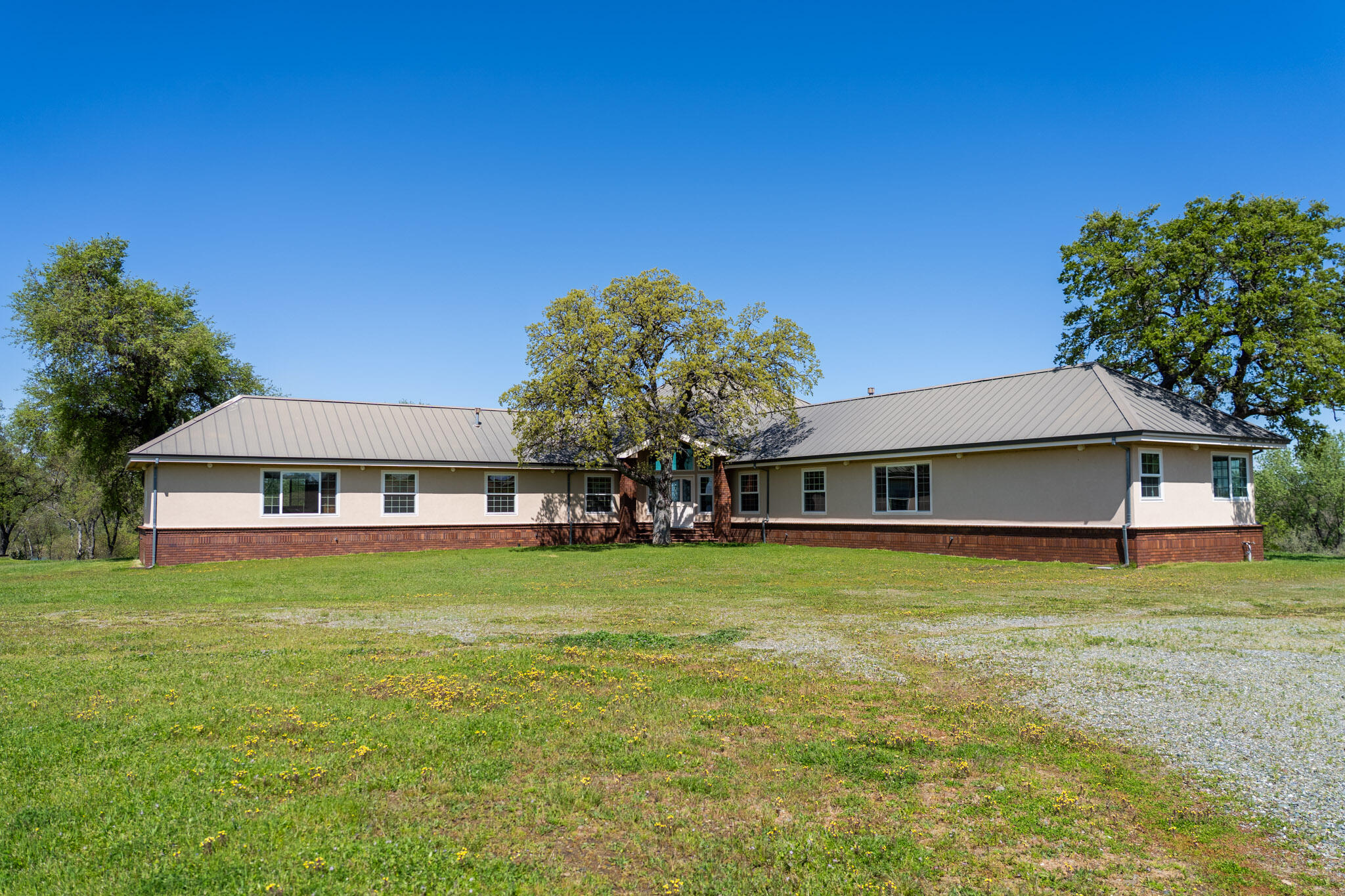17935 Rivers Edge Drive Red Bluff, CA 96080 - Photo 5 of 38 a front view of a house with a garden and trees