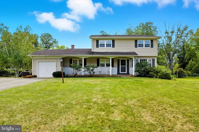 a view of a house with a big yard and potted plants