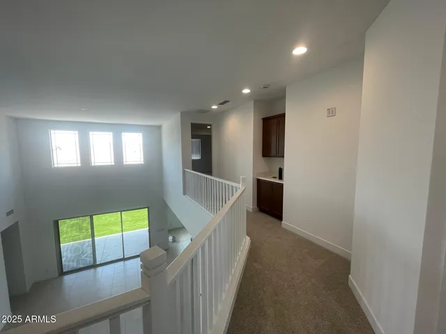 a view of a hallway with a livingroom with furniture