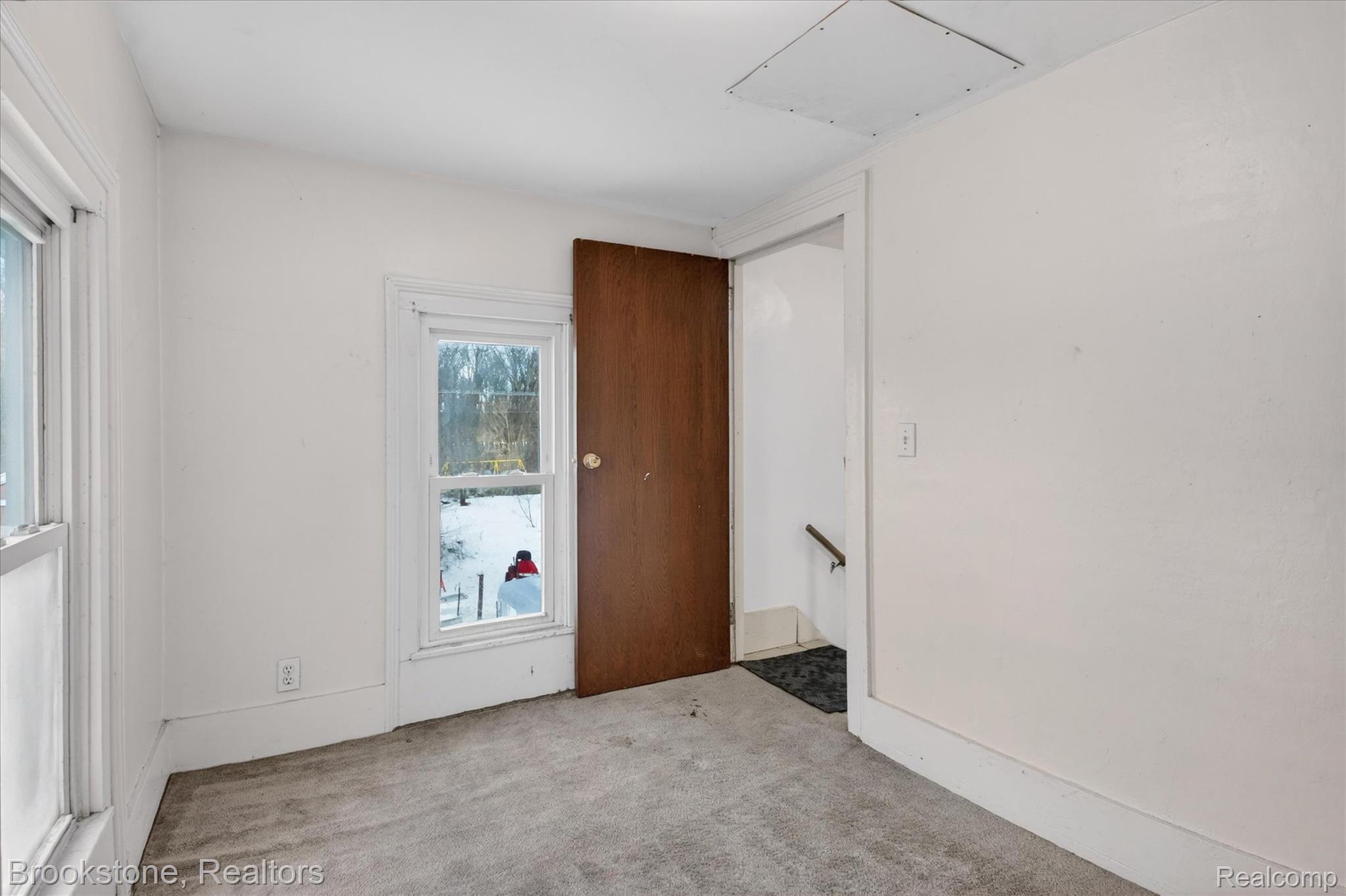 6756 West Beard Road Perry, MI 48872 - Photo 26 of 32 Empty room featuring carpet and attic access