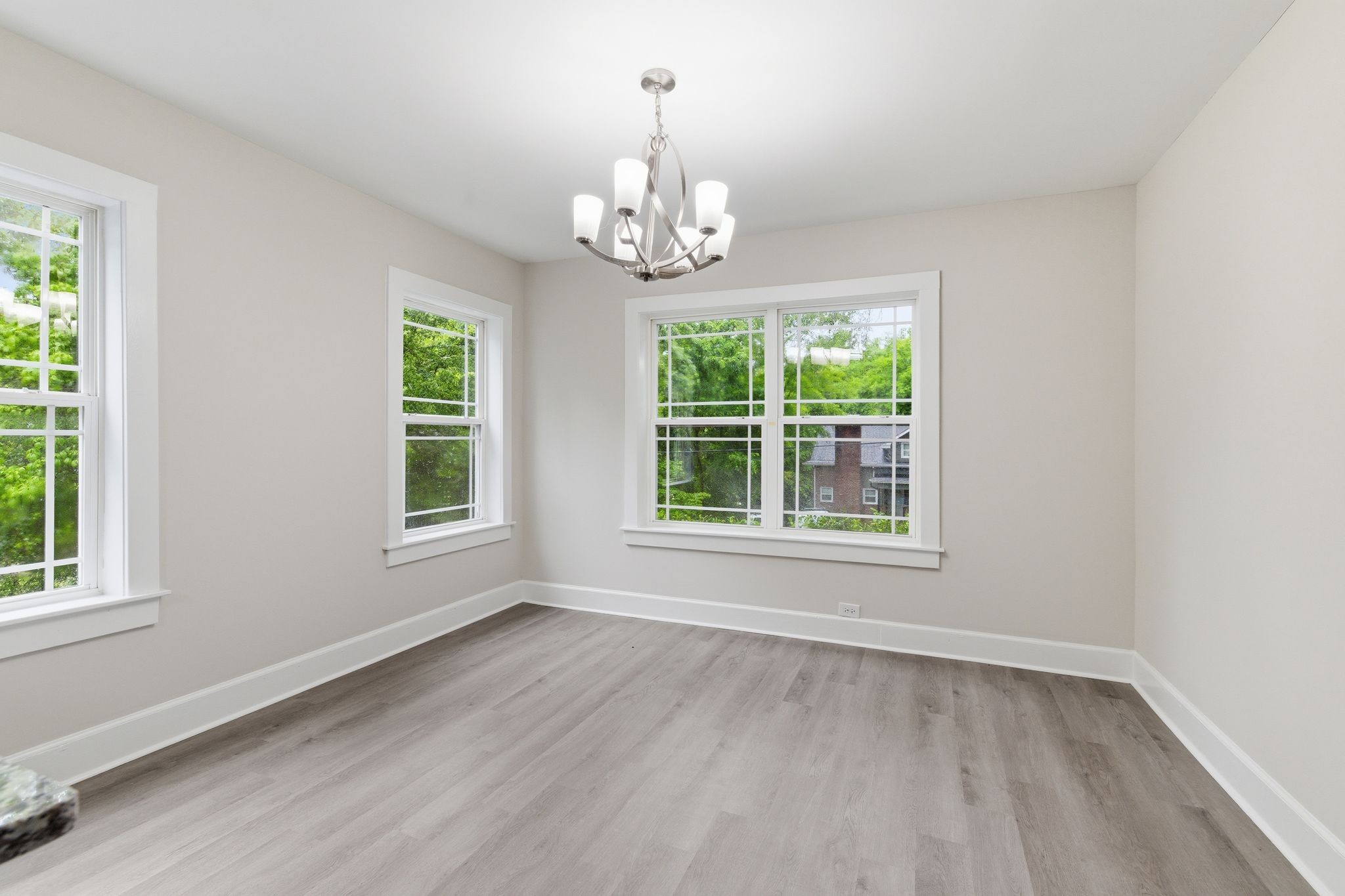 305 South Irwin Street Manchester, TN 37355 - Photo 11 of 40 an empty room with wooden floor chandelier and windows