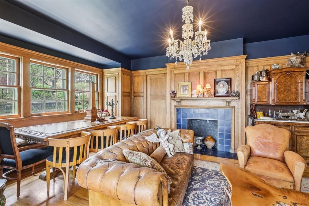 4352 Centre Avenue Pittsburgh, PA 15213 - Photo 13 of 45 a living room with furniture a chandelier and a fireplace