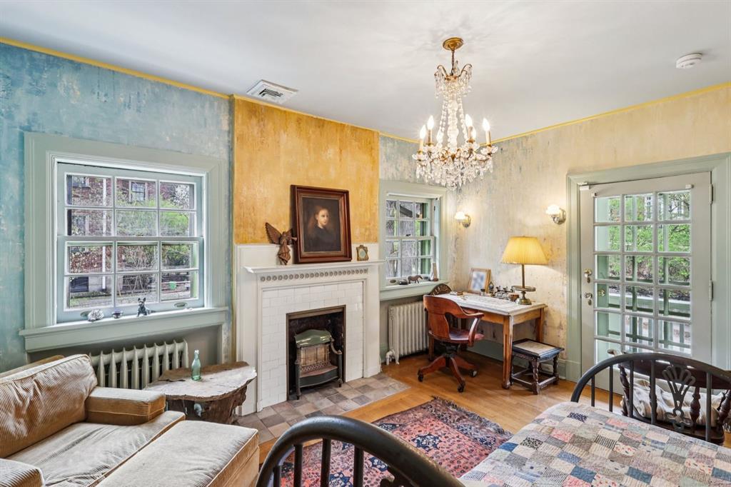 4352 Centre Avenue Pittsburgh, PA 15213 - Photo 15 of 45 a living room with furniture a fireplace and a chandelier