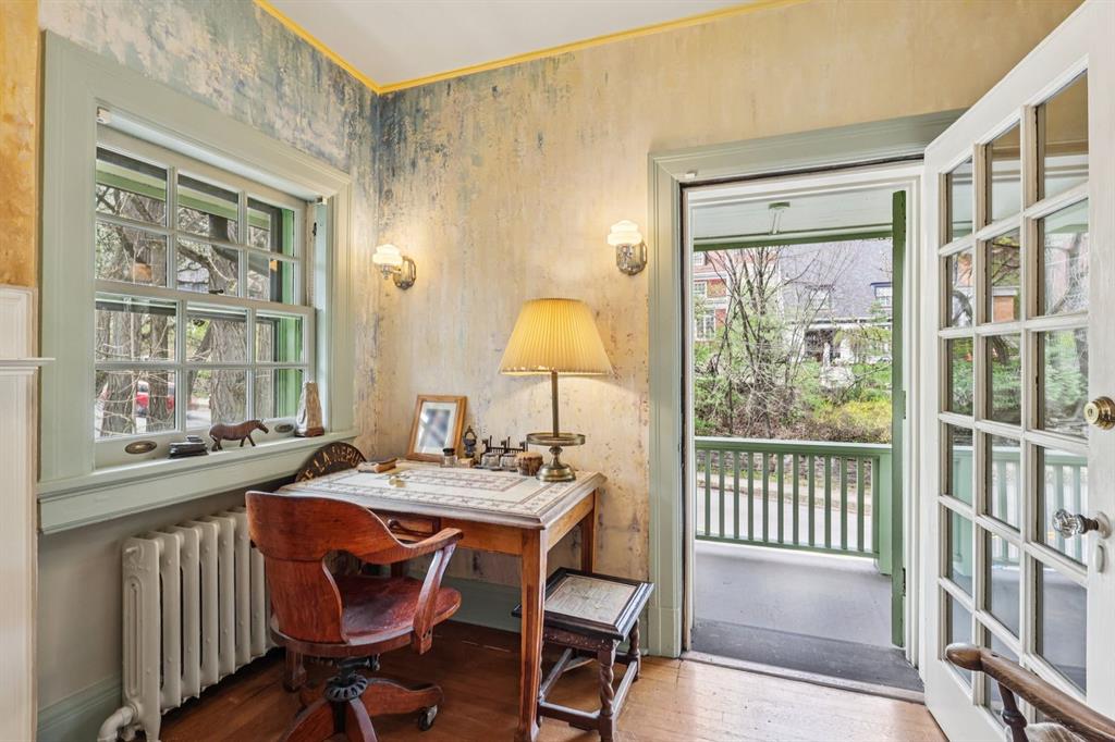 4352 Centre Avenue Pittsburgh, PA 15213 - Photo 16 of 45 a dining room with wooden floor a chandelier a wooden table and chairs