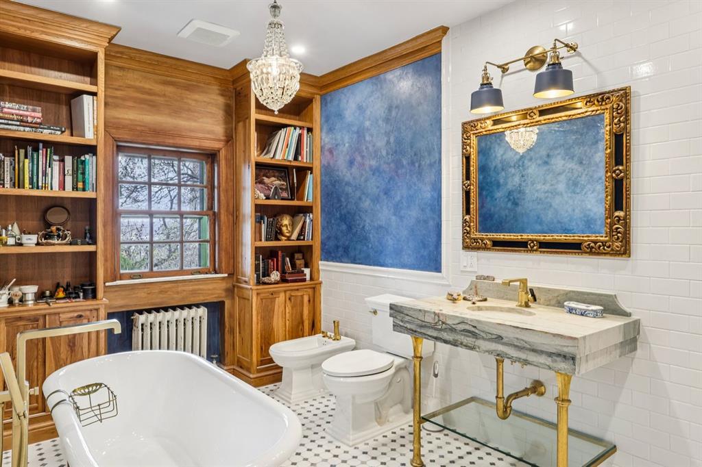 4352 Centre Avenue Pittsburgh, PA 15213 - Photo 23 of 45 a bathroom with a granite countertop sink a toilet and a mirror