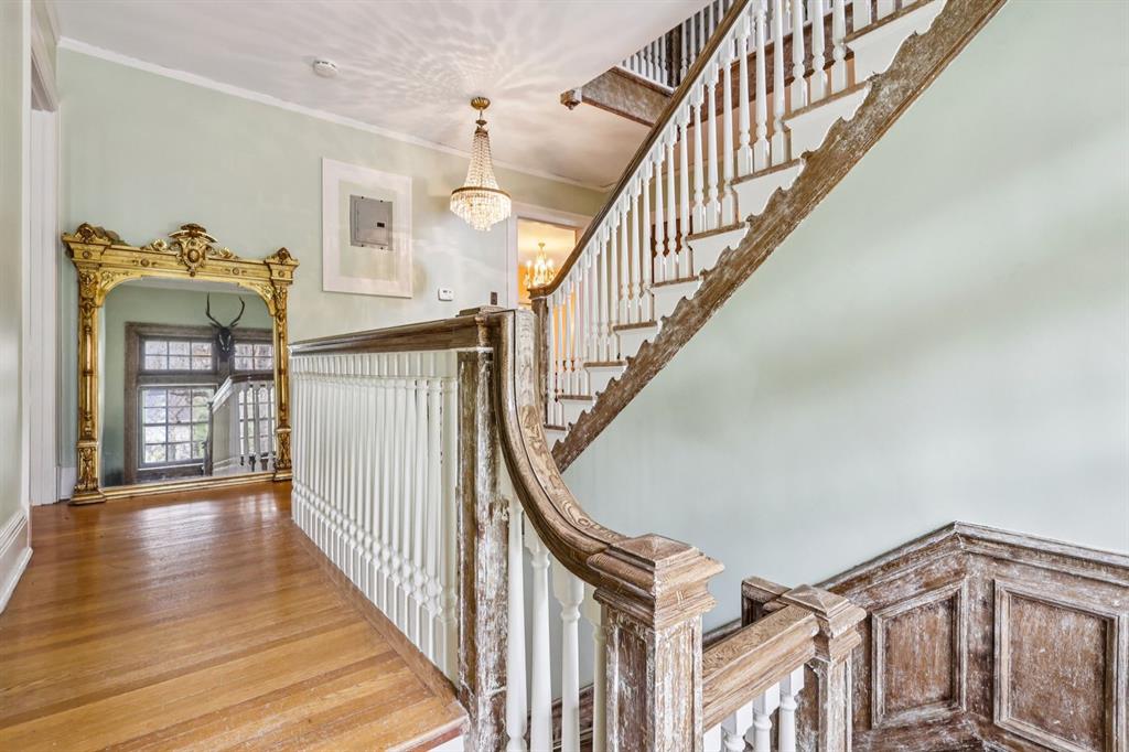 4352 Centre Avenue Pittsburgh, PA 15213 - Photo 26 of 45 a view of staircase with lots of frames on wall and wooden floor