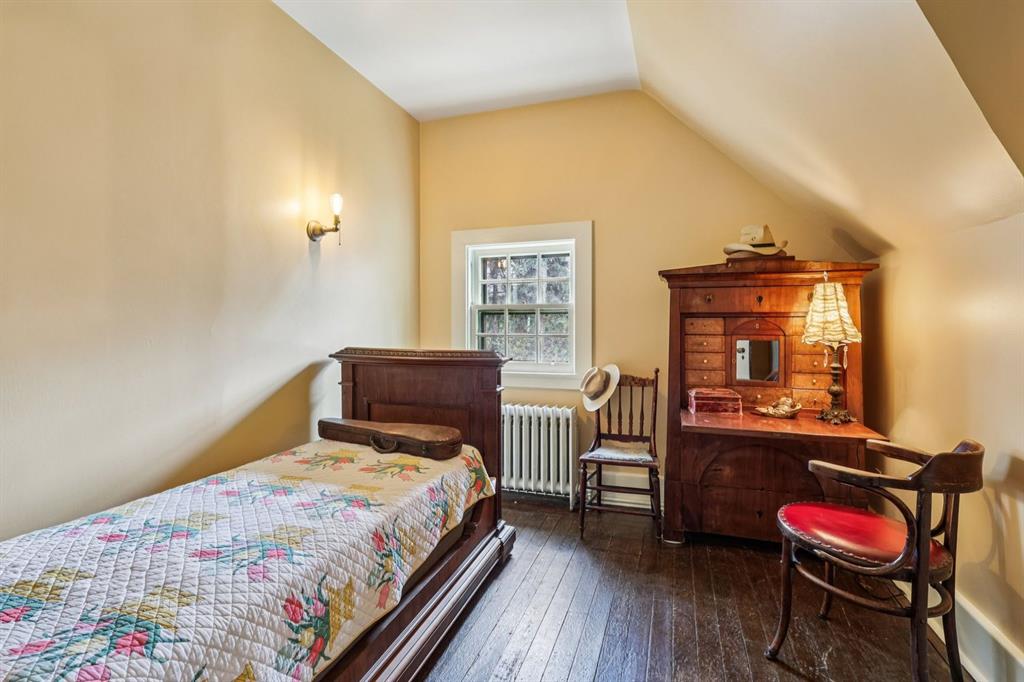 4352 Centre Avenue Pittsburgh, PA 15213 - Photo 27 of 45 a bedroom with a bed and wooden floor