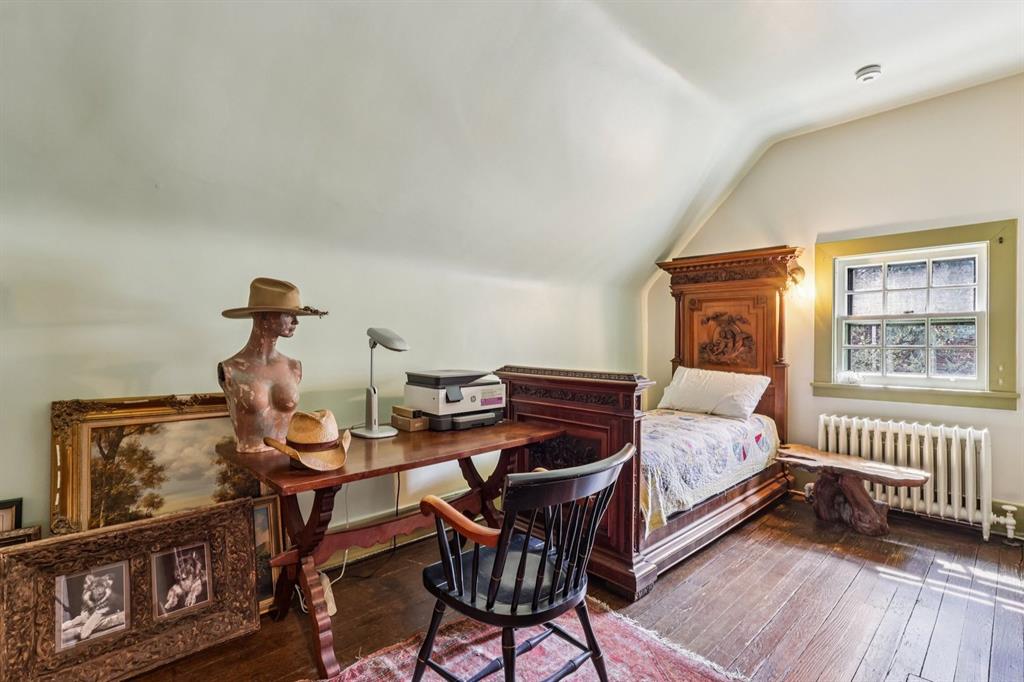 4352 Centre Avenue Pittsburgh, PA 15213 - Photo 28 of 45 a bedroom with a bed and wooden floor