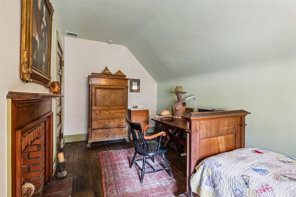 4352 Centre Avenue Pittsburgh, PA 15213 - Photo 29 of 45 a bedroom with a bed and wooden floor