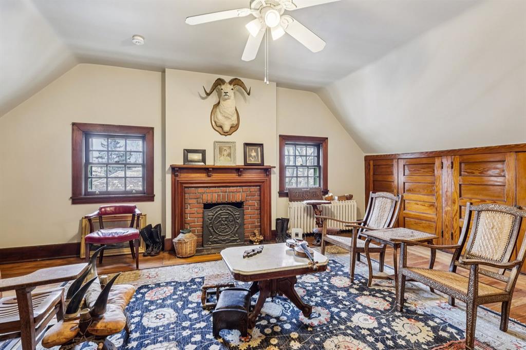 4352 Centre Avenue Pittsburgh, PA 15213 - Photo 30 of 45 a living room with furniture a fireplace and a large window