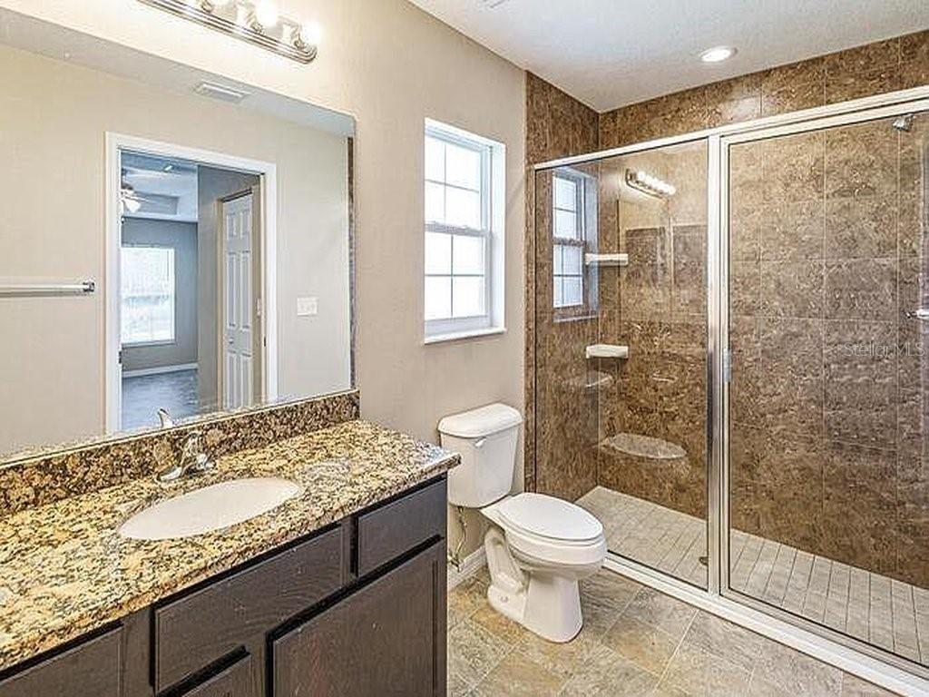 1 Pecan Course Circle Ocala, FL 34472 - Photo 11 of 24 a bathroom with a granite countertop sink toilet and shower