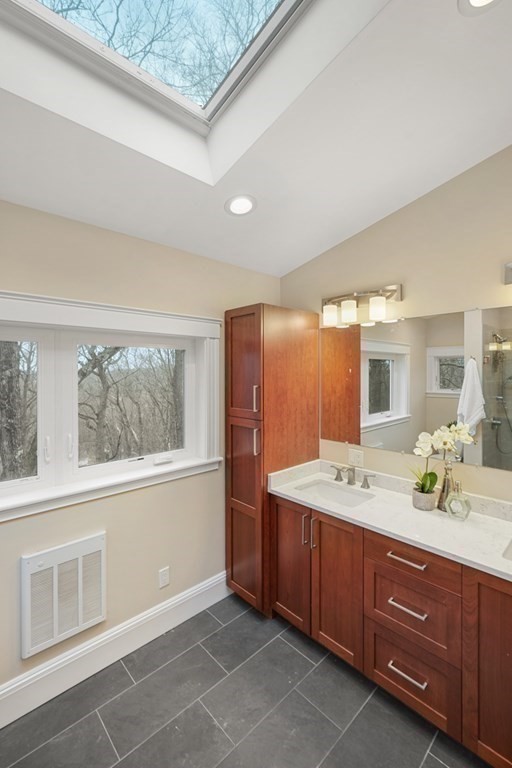 93 Wolcott Road Brookline, MA 02467 - Photo 27 of 41 a spacious bathroom with a granite countertop sink mirror and double