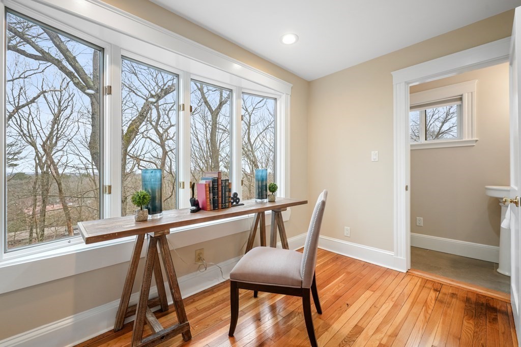 93 Wolcott Road Brookline, MA 02467 - Photo 4 of 41 a view of a room with a large window and wooden floor