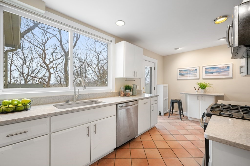 93 Wolcott Road Brookline, MA 02467 - Photo 9 of 41 a kitchen with a sink cabinets and wooden floor