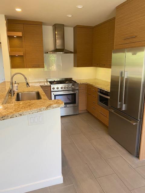 1111 East Ramon Road, Unit 10 Palm Springs, CA 92264 - Photo 2 of 23 a kitchen with stainless steel appliances granite countertop a sink a stove and a refrigerator