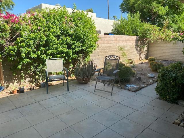 1111 East Ramon Road, Unit 10 Palm Springs, CA 92264 - Photo 19 of 23 a bench and bench sitting in backyard of a house