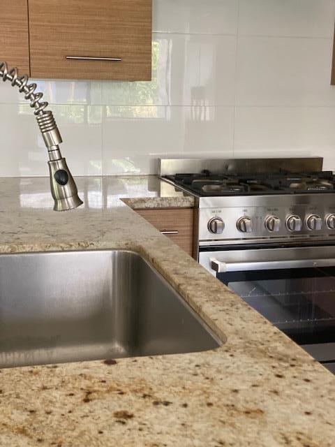1111 East Ramon Road, Unit 10 Palm Springs, CA 92264 - Photo 8 of 23 a kitchen with a stove and a sink