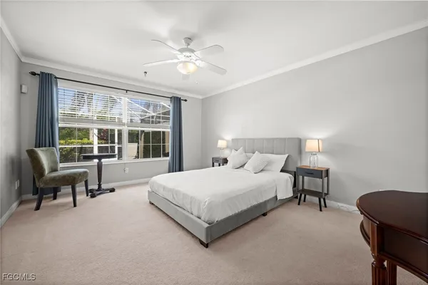 a bedroom with a bed a chair and a chandelier