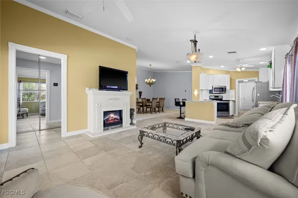 a living room with furniture a fireplace and a flat screen tv
