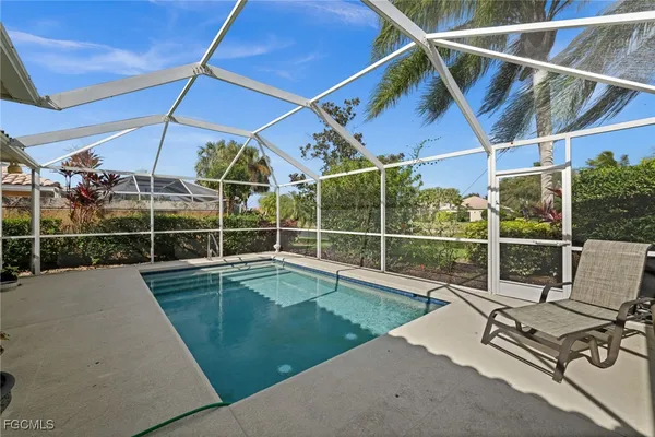 a view of a backyard with a swimming pool