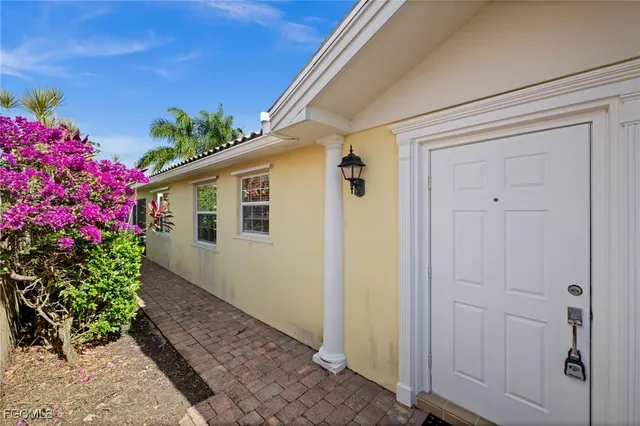a kitchen with granite countertop sink and refrigerator