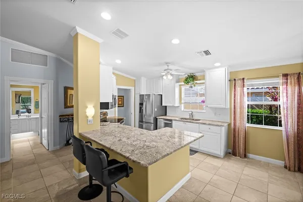 a view of a dining room with furniture and a chandelier
