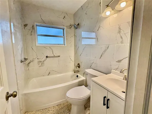 a bathroom with a sink a toilet and a bathtub