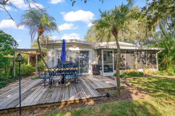 a view of a dinning table and chairs in patio of the house
