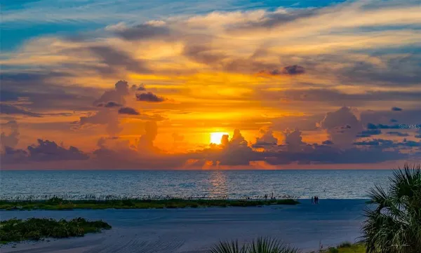 a view of a lake with sunset in the background