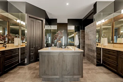 a kitchen with kitchen island stainless steel appliances a sink stove and refrigerator
