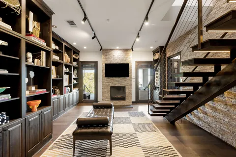 a living room with furniture a flat screen tv and a fireplace