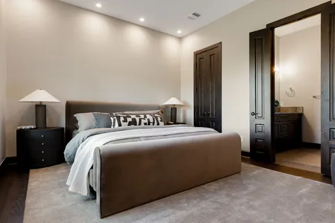 a bedroom with a bed and a lamp